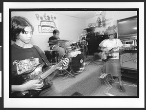 Youths of Filipino origin in rock & roll band rehearsal, SOMA, San Francisco, California, 2002