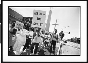 People carrying a cross during an anti-violence march, 1996