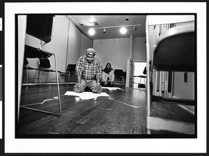 Muslim man and woman praying after preparing food for First Congregational Church homeless women's dinner program, 945 G street, NW, Washington, DC, 2002