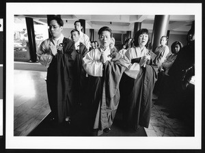 People in robes praying, Los Angeles, 1999