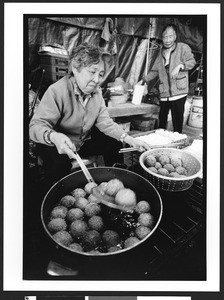 Elderly woman of Vietnamese origin preparing fried food. Chua Duc Vien Pagoda, or Perfect Harmony Temple, San jose, California, 2002