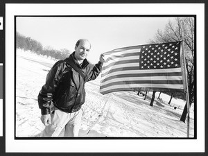 Russian immigrant holding American flag in front of the Lincoln Memorial, The Ellipse, Washington, D.C., 2002