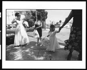 Woman in wedding dress with flower girl in front, Dolores, Los Angeles, 1996