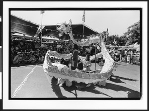 Group of dancers of Vietnamese origin performing dragon dance in front of large group of people of Vietnamese origin, San Jose, California, 2002