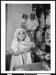 Little girl holding bananas, Los Angeles, 1999