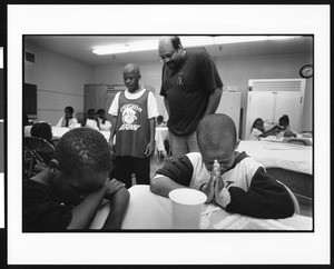 Two children in prayer at evening program, Los Angeles, 1996