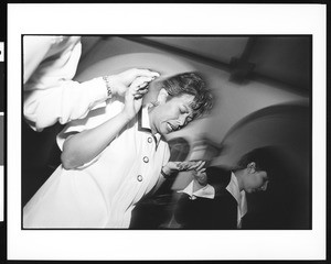 Woman in prayer holding hands with others, St. Thomas, Los Angeles, 1996