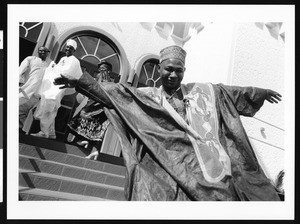 Man in traditional African dress skipping down the stairs, Los Angeles, 1999