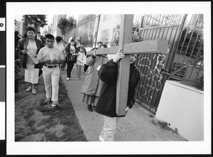 Two women carrying large cross at head of procession, Los Angeles, 1999