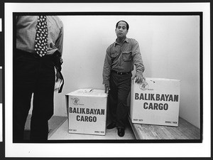 Man of Philipines origin with two Balikbayan cargo boxes, SOMA, San Francisco, California, 2002