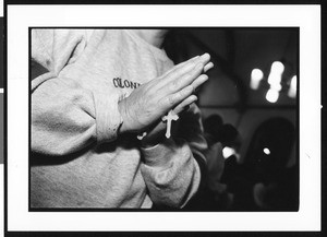 Person at mass in prayer at Saint Thomas Church (Los Angeles, Calif.), 1996