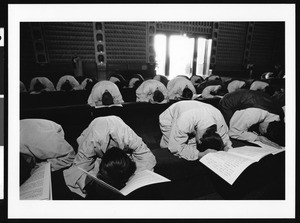 People bowing in prayer, Los Angeles, 1999