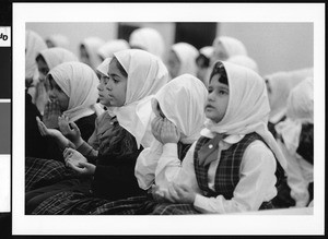 Young girls sitting in uniforms and head coverings, Los Angeles, 1999