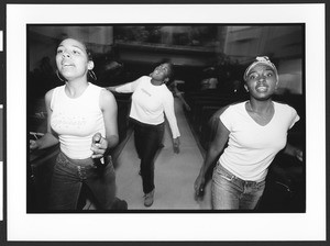 Three teenage girls singing and dancing at First AME Church, Los Angeles, California, 2003