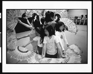 Young girls performing with fans, Oriental (Los Angeles), 1996