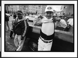 Men of South American origin waiting for day work (Listo) on Cesar Chavez Street, San Francisco, California, 2002