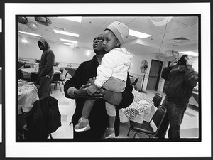 Reverend Olumide conducts a prayer, at thanksgiving dinner for homeless people, "Jesus House" Redeemed Christian Church of God, Silver Springs, Maryland