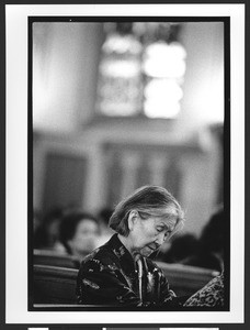 Old woman of Filipino origin, praying inside Saint Patrick's Catholic Church, San Francisco, California, 2002