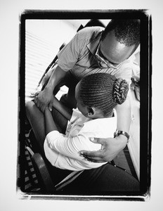 Man holding a woman in a comforting manner Rwanda, 2004