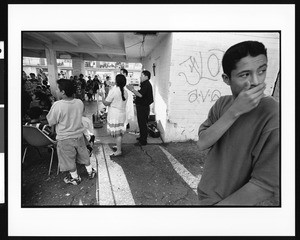 Group singing in prayer with a young man looking away, Dolores, Los Angeles, 1996