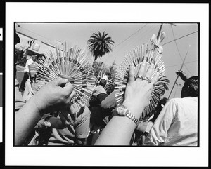 Hands holding palm circles in the Palm Sunday procession, Los Angeles, 1996