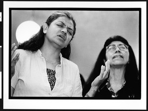 Two women of South American origin in prayer, First Church of God, the Mission District, San Francisco, California, 2002