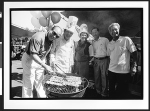 Five men of Vietnamese origin preparing barbecue at Vietnamese festival, Our Lady of Peace, San Jose, California, 2002