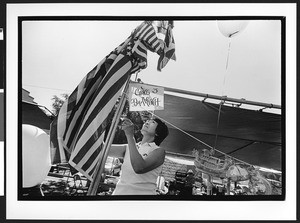 Woman of Vietnamese origin raising American Flag, Our Lady of Peace, San Jose, California, 2002