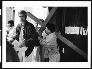 Man carrying wooden cross, 1999