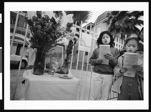 Two young girls singing in prayer, Los Angeles, 1999