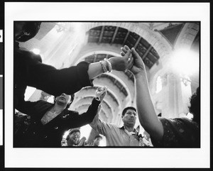 People holding hands in prayer on Palm Sunday at St. Vincent Catholic Church (Los Angeles, Calif.), 1996