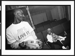 A man of African origin with children, Saint James Healing Church of Christ, Bladensburg, Maryland