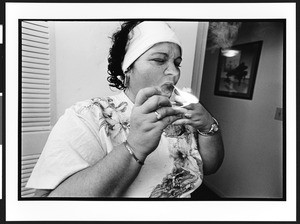 Marissa, a Santeria priestess, also known as a lyalrishas, or mother of Orisha, the Santeria god, in her home, 399 NW 72nd Avenue & 3rd Street, Miami, Florida, 2002