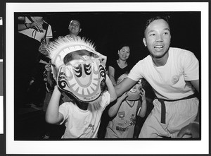 Children and adults of Vietnamese origin participate in Dragon dance, Harvest Moon Festival, Tet Trung Thu, San Jose, California, 2002