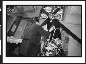 Woman of Filipino origin touching statue of Jesus, interior of Saint Patrick's Catholic Church, San Francisco, 2002