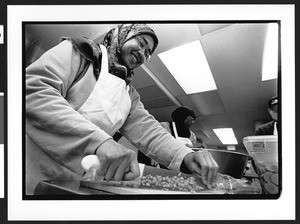 Muslim women preparing food for First Congregational Church homeless women's dinner program, 945 G street, NW, Washington, DC, 2002