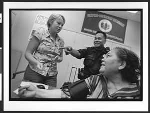 Nurse with patient of Filipino origin, interior of West Bay Area Pilipino Multi-Service Center, SOMA, San Francisco, California, 2002