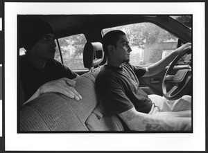 Inside of an automobile with two young men , San Salvador