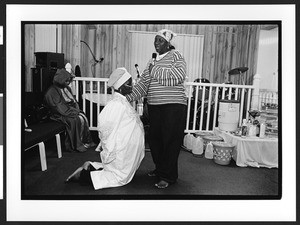 A woman of African origin receives a blessing during services, Saint James Healing Church of Christ, Bladensburg, Maryland