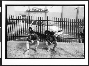 Two men of South American origin waiting for day work (Listo) on Cesar Chavez Street, San Francisco, California, 2002