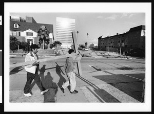 Two men carrying a wooden cross, 1999