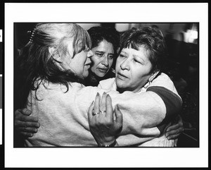 Three women hugging at Mass, St. Thomas, Los Angeles, 1996