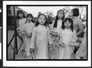 Ao dai clad children with flower head bands are holding decorative artificial flowers at Tet Trung Thu, San Jose, California, 2002