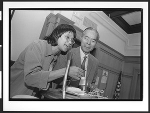 Two people of Chinese origin on stage giving award, Cameron House, Family Day, Chinatown. San Francisco, California, 2002