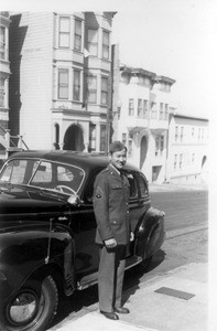 Edward Paik, sargeant, beside car