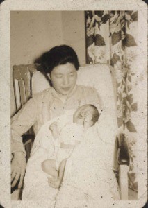 Lee DeYoung at one week old, with his mother