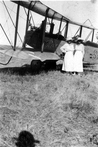 Two women standing beside airplane at Redwood Aviation School