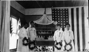 4 women in front of temple model and US flag