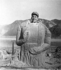 Martin J. Bolhower posing with headless statue