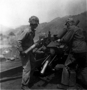 Gunnery team loads shells